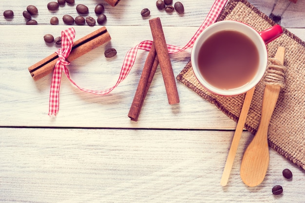 Red cup with espresso, cinnamon and spoon 