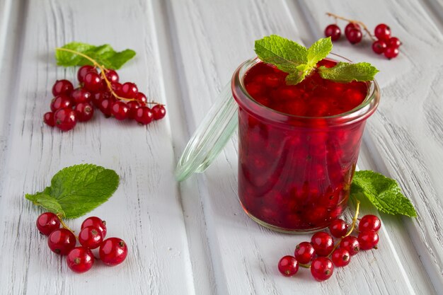 Red currant compote in the glass jar