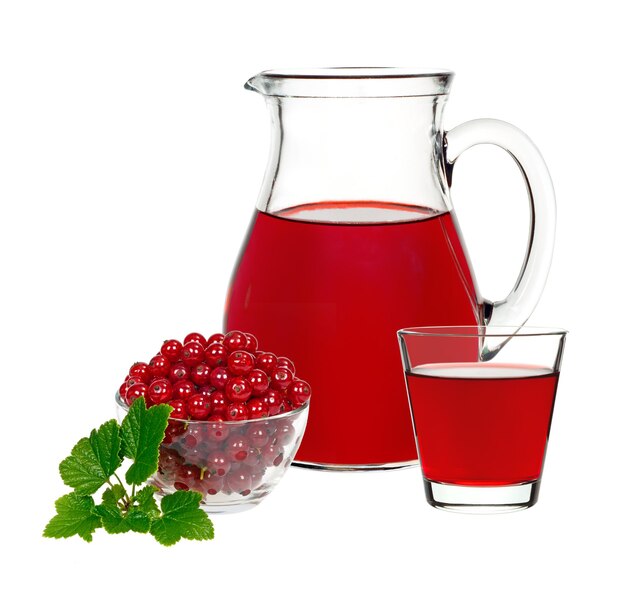 Red currant drink in a glass and a decanter with berries currants on a white background