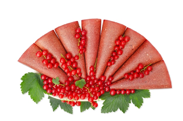 Red currant pastille on a white plate Isolation on a white background