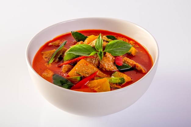 Red Curry Pork and Vegetables (Panaeng), on a white background