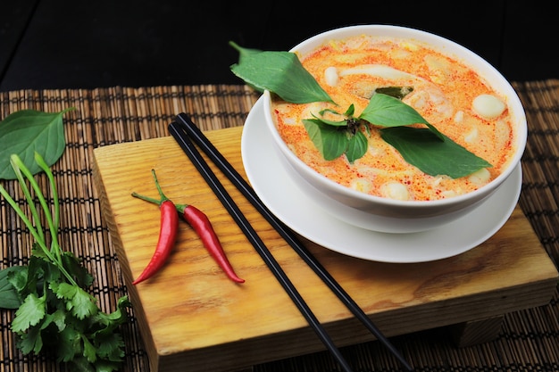 Red curry in a white bowl, chopsticks, oriental food