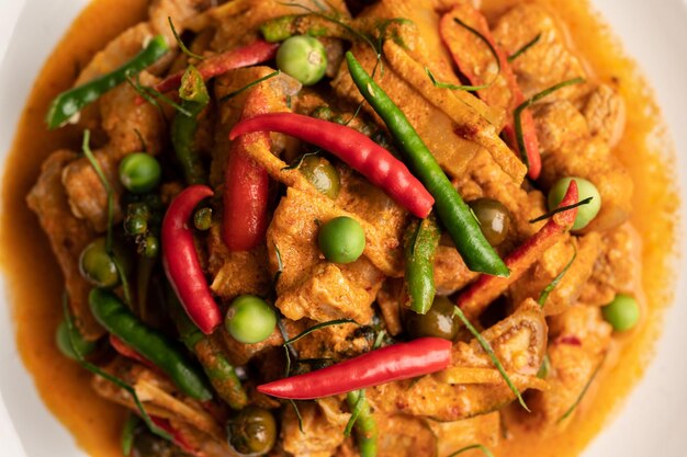 Red curry with pork in a white plate