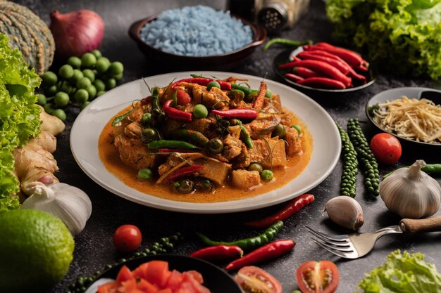 Red curry with pork in a white plate