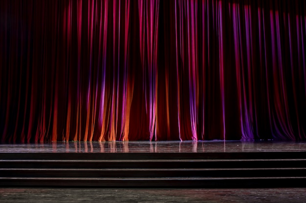 Red curtains and wooden stage.