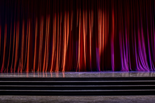 Red curtains and wooden stage.