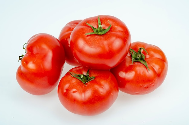 Red, dark pink ripe tomatoes isolated on white background. Studio Photo.