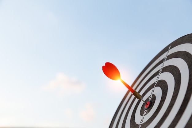 Red dart target arrow hitting on bullseye with,Target marketing and business success concept