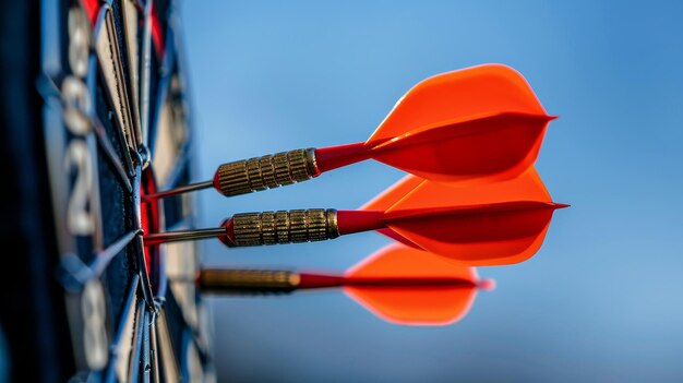 Photo red darts striking the bullseye in a target captured in a close up with a dark blue sky backdrop