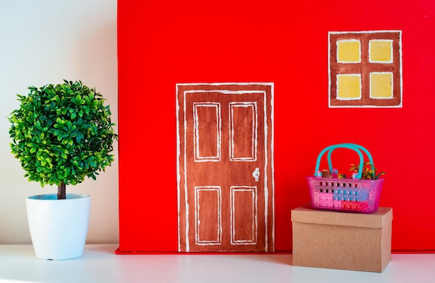 Red decorative house with toy parcels and products delivery of
contactless boxes and products