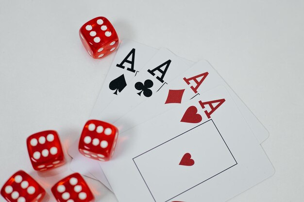 Red dice and cards scattered on table closeup Casino concept