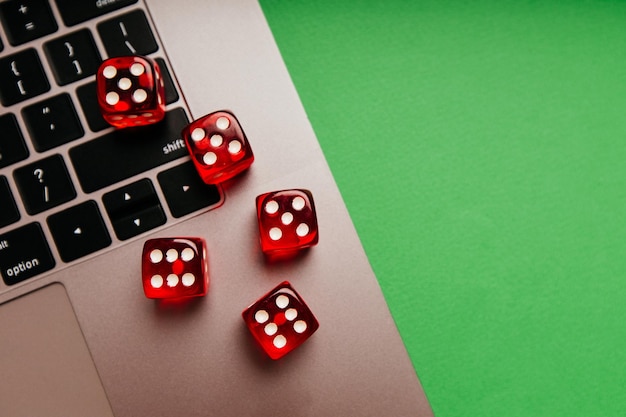 Red dice on a keyboard Top view Online gambling and casino concept