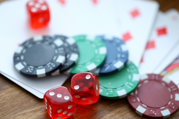 Red dices lying with casino chips as gambling symbol