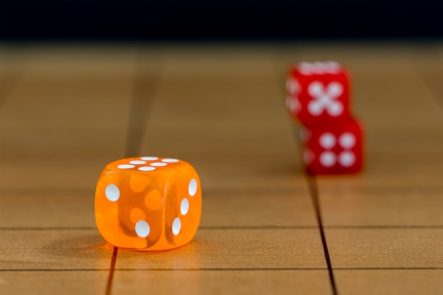 Red dices on wood board