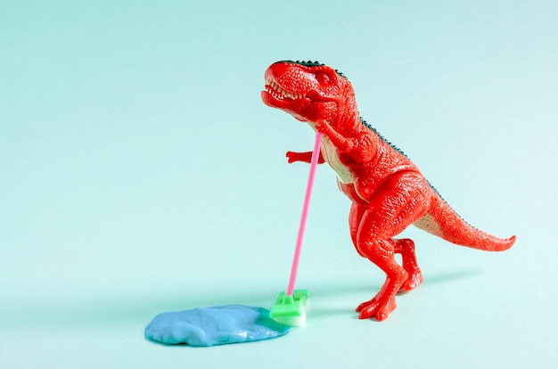 The red dinosaur is cleaning the floor with a brush Cleaning concept