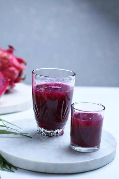 red dragon fruit smoothie served in glasses