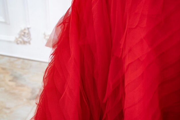 A red dress with ruffles and a white background