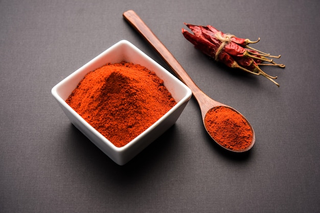 Red dried Mirchi mirch or Chilly Powder in a bowl over moody background, selective focus