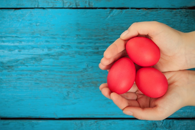 Red easter eggs in the hands