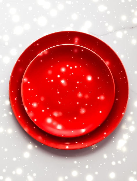 Red empty plate on marble table flatlay background tableware decoration for romantic holiday dinner in christmas time and valentines day