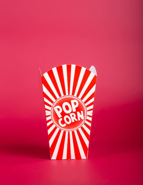 Red empty popcorn bucket on red background. Isolated image