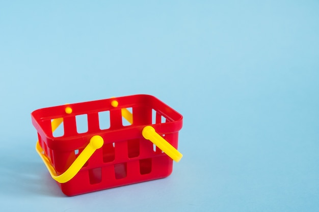 Red empty toy plastic shopping basket