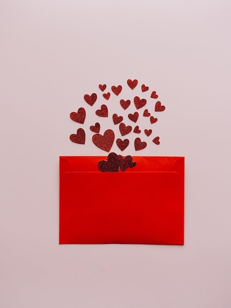 A red envelope with hearts and a red box with hearts on it.