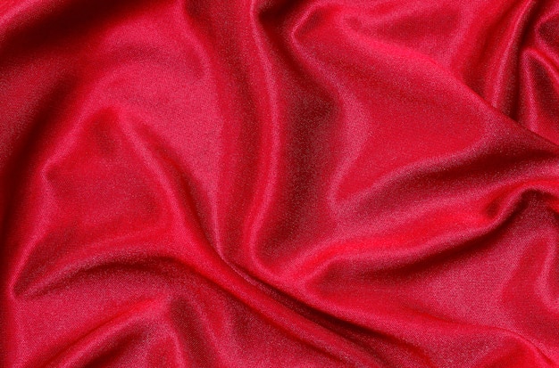 Red fabric cloth texture for background, beautiful crumpled silk or linen.