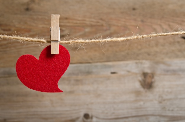 Red fabric heart hanging on a clothesline