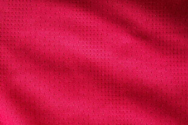 Red fabric sport clothing football jersey with air mesh texture background