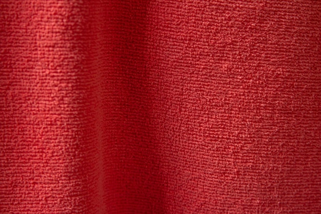 A red fabric with a pattern of small squares.