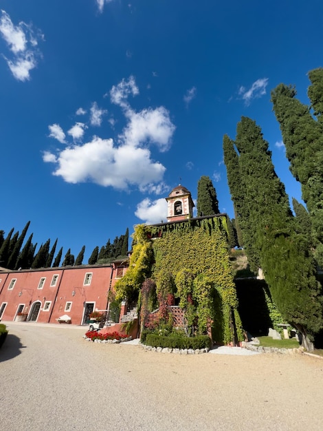 Red facade of the villa cordevigo wine relais is covered with ivy italy