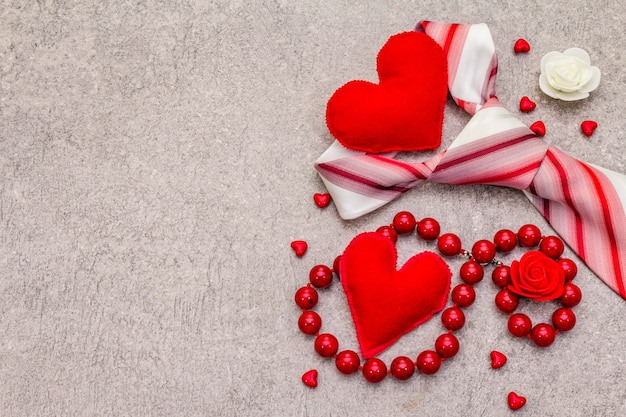 Red felt hearts, beads and a tie
