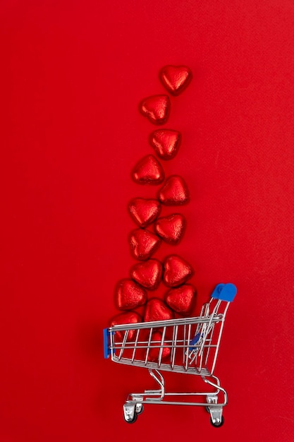 Red festive Christmas background with a supermarket cart