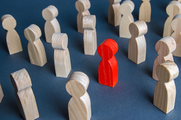 Red figurine of a man in a crowd of people Stranger eyecatching Different special Infected carrying threat of spread of a pandemic Collective immunity Social distance Intruder detection