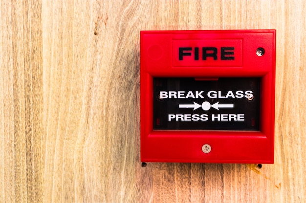 Red fire alarm with glass in the center