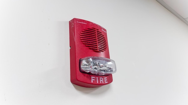 A red fire alarm with the word fire on it