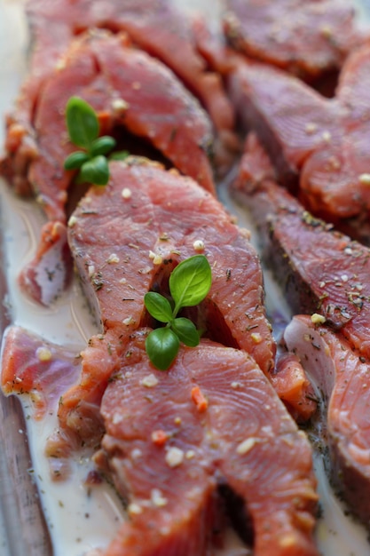 Red fish is cut into steaks and covered in creamy sauce