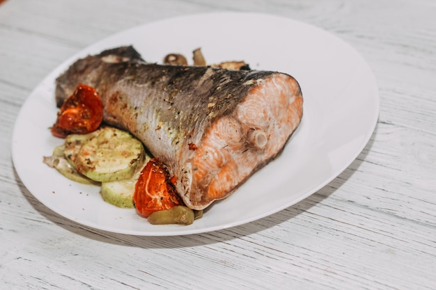 Red fish trout salmon baked in the oven with vegetables