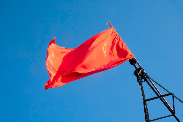 Red flag against the sky