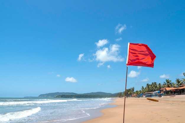 Red flag as warning sign on the beach before storm means no swimming during windy sunny dayx9