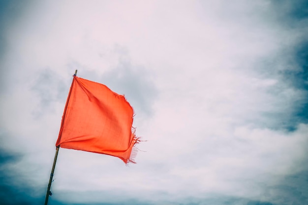 Red flag warning flags wind blue sky