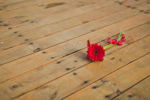 The red flower on the wooden floor 6525