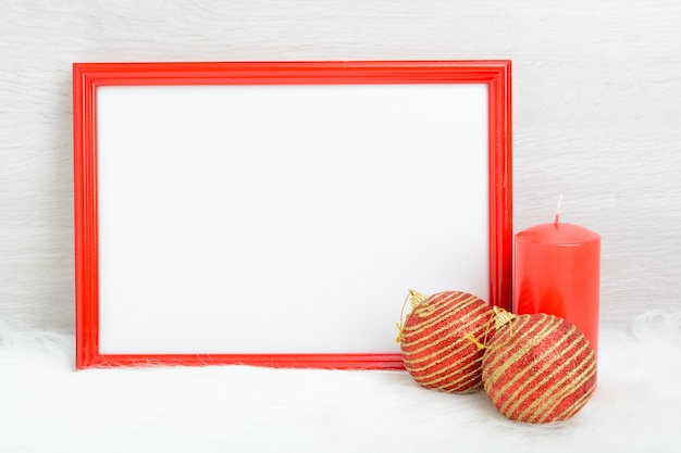 Red frame, candle and Christmas toys