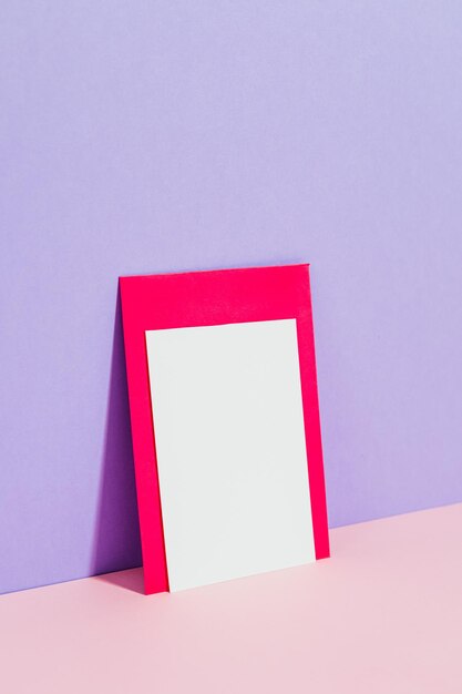 A red frame with a white frame on the purple wall