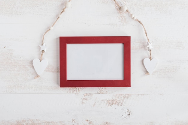 Photo red frame with white wooden hearts