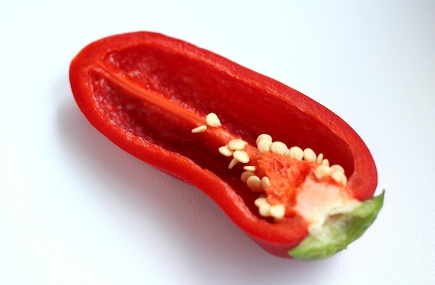 Red fresh pepper in a cut on a light background