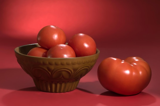 Red fresh tomatoes on a red background