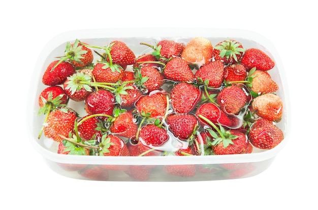 Red freshly Strawberry inside cold water sweet spring strawberries closeup on white background