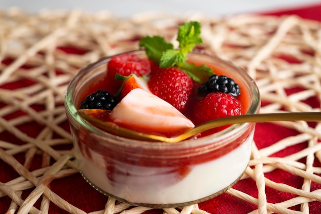 Red fruit panna cotta with strawberries. Italian recipe.